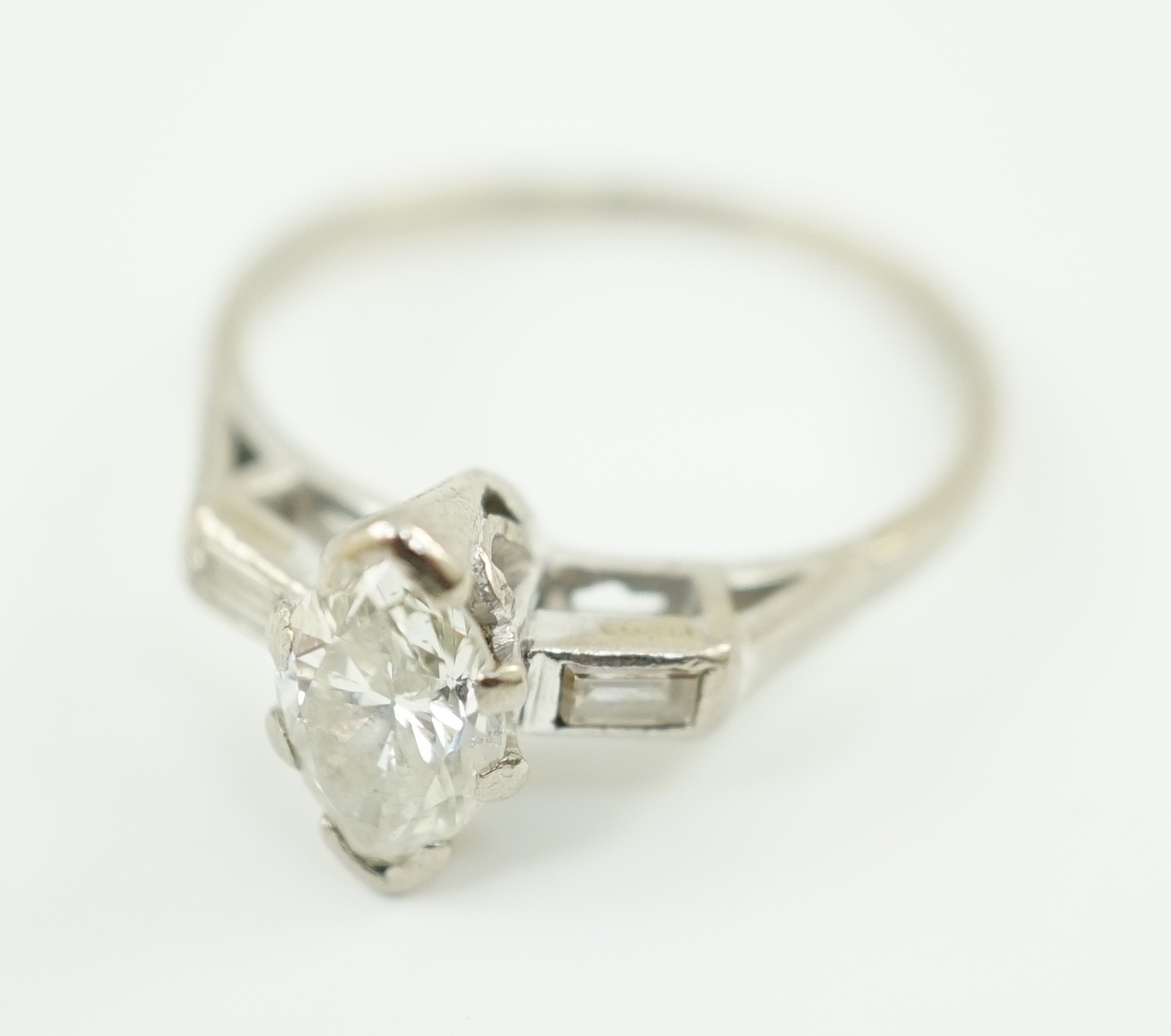 An 18ct white gold and single stone marquise cut diamond set ring, with baguette cut diamond set shoulders